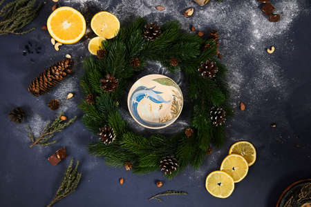 Christmas, new year. Blue background, nuts, powdered sugar, ceramic utensils in the center.の写真素材