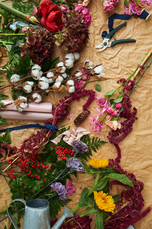 Composition flat-lay of flowers and florists instruments on parchment paper craftの写真素材