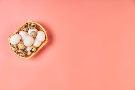 Eggs for Easter in a basket pink backgroundの写真素材