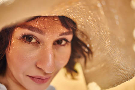 A close portrait of a woman in a summer hatの写真素材