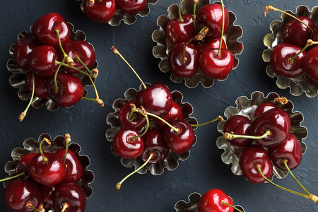 Sweet ripe cherry in cake form on dark blue background. Top view.の写真素材
