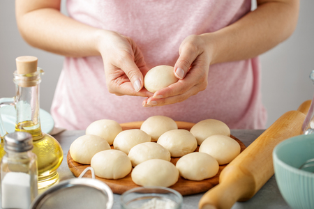 Woman make dough balls for cooking mexican flatbread. Step by step recipe of homemade tortillas.の写真素材