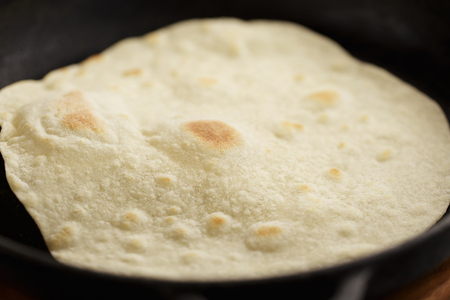 Tortilla fried on cast iron pan. Step by step recipe of homemade mexican flatbread.の写真素材