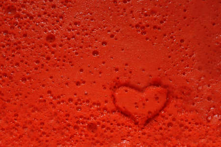 heart stamp prints burst bubbles on a red backgroundの写真素材