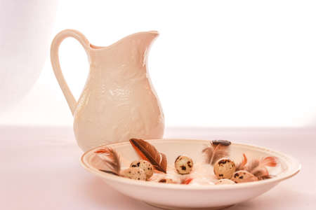 Easter table setting with eggs and nest And a jugの写真素材