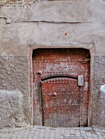 Old moroccan mysterious, damaged door in Marrakesh の写真素材