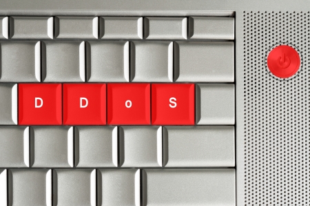 distributed denial of service in red on a metallic keyboardの写真素材