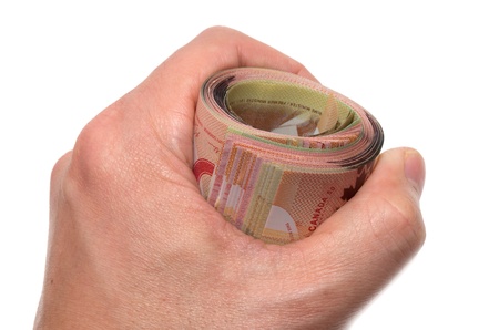Hand holding a roll of 50 dollars Canadian の写真素材