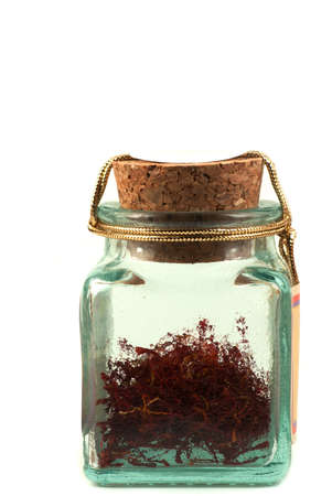 Safran in a glass jar on white backgroundの写真素材
