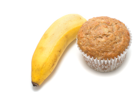 Fresh baked homemade muffin and a banana white background. の写真素材