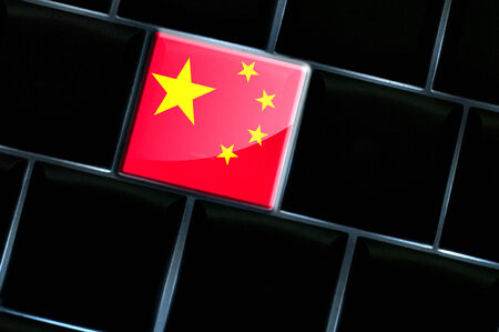 Chinese online concept with flag over the backlit keyboardの写真素材