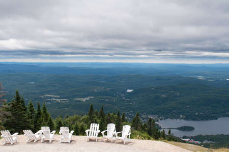 White chairs on top of mountain  at a ski resort during summer time depicting relaxing conceptの写真素材