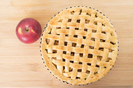 Baked apple pie against wooden backgroundの写真素材