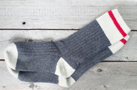 Pair of wool socks against wood backgroundの写真素材