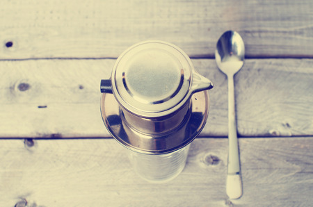 Vietnamese iced coffee against wooden background with retro filter appliedの写真素材