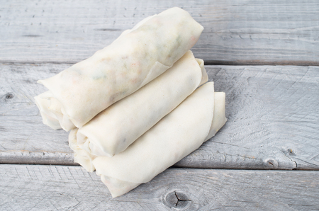 Uncooked Vietnamese egg rolls, Cha Gio,  on a wooden tableの写真素材