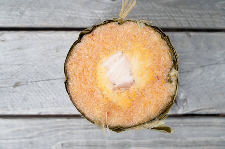 Vietnamese conical sticky rice cake stuffed with pork belly on wooden background