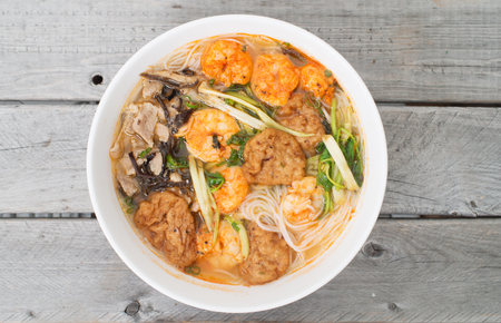Bun Tom Hai Phong, Vietnamese shrimp and fish balls soup against wooden background