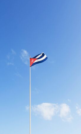 Cuban flag waving in the air over a blue skyの写真素材