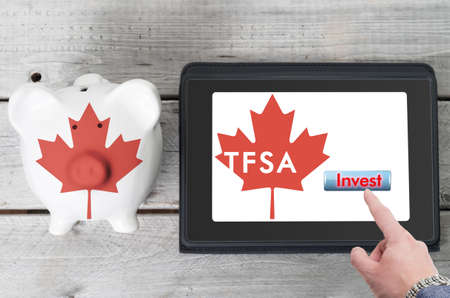 Canadian Tax-Free Savings Account online investment  concept with a piggy bank and digital tablet