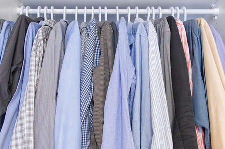 Men shirts hang on a clothes hangerの写真素材