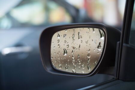 Left side car mirror showing rain dropletsの写真素材