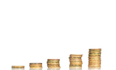 Five stacks of coins forming steps up isolated on white backgroundの写真素材