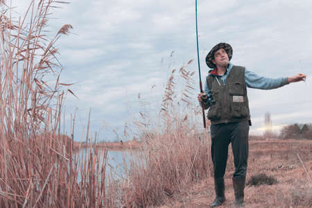 A man enjoys in the free time he spends himself on fishingの写真素材