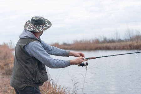 A man enjoys in the free time he spends himself on fishingの写真素材