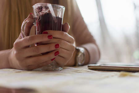 human hands on a cup of tea-close upの写真素材