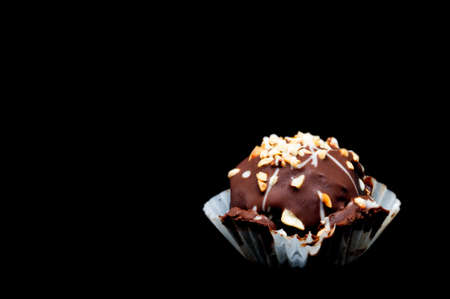 chocolate ball with topping in black backgroundの写真素材