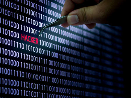 Computer screen shot with binary code and hacker text, great concept for technology computer and online securityの写真素材
