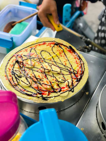 Selective focus making banana crepes with  chocolate creamの写真素材