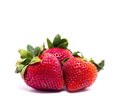 Closeup shot of fresh strawberries. Isolated on white background.の写真素材