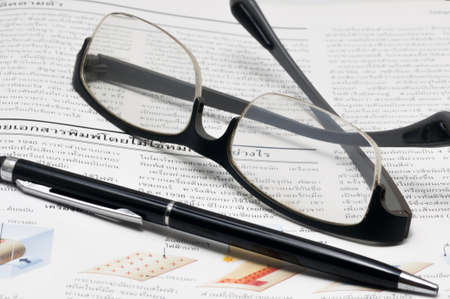 Glasses and pen on the open book,thai language bookの写真素材