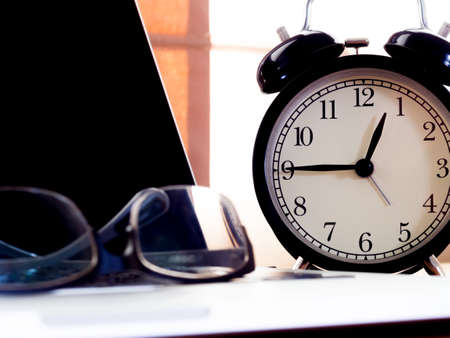 The glasses on the laptop with clock, Work hard for Goal,Business conceptの写真素材