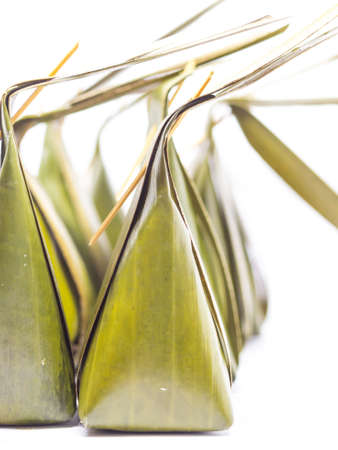 Thai Traditional Dessert (The banana leaf wrapped with coconut steamed flour),Kanom Sai Sai on white backgroundの写真素材