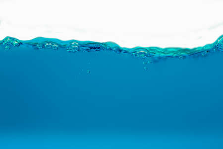 the Close up blue Water splash and air bubbles on white background