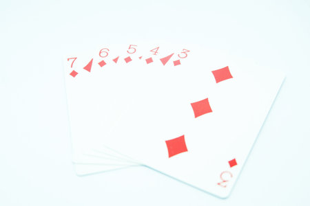 A straight flush of diamond hand in poker consisting of the three, four, five, six, and seven of diamondsの写真素材