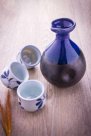 Japanese Sake drinking set on old wood texture backgroundの写真素材