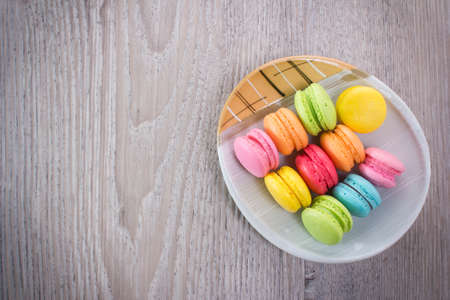 Sweet colorful macaroons on a wood backgroundの写真素材