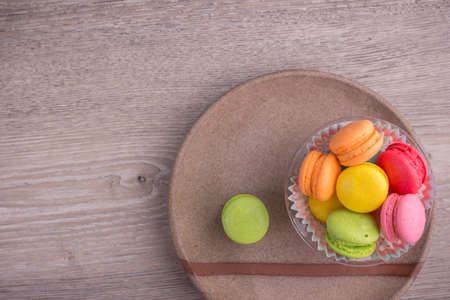 Sweet colorful macaroons on a wood backgroundの写真素材