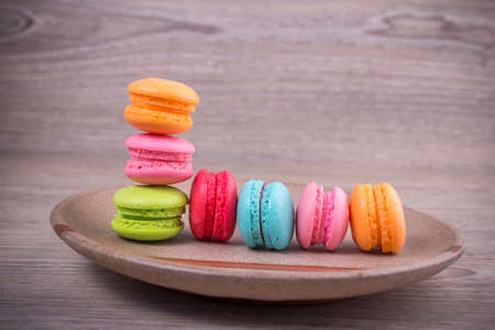 Sweet colorful macaroons on a wood backgroundの写真素材