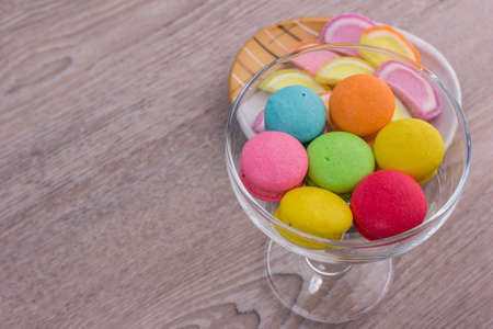 Sweet colorful macaroons on a wood backgroundの写真素材