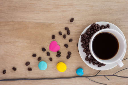 cup of espresso coffee with colourful French macarons on wooden backgroundの写真素材