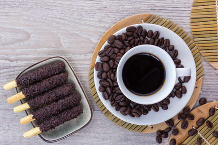 Coffee and coffee beans arranged on a wooden table, View from above with copy spaceの写真素材