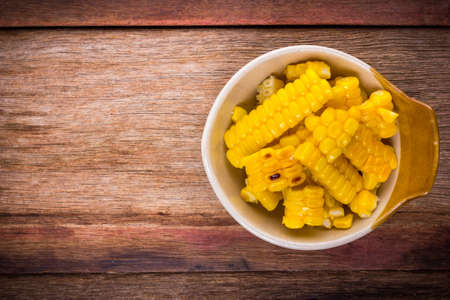 split corn on wood background, View from above with copy space.の写真素材