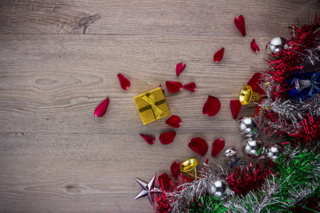 Christmas background with brown, star and golden bell decorations on wooden table. View from above with copy spaceの写真素材