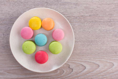 Sweet colorful macaroons on a wood backgroundの写真素材