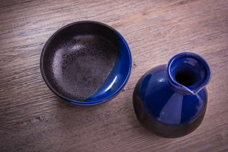 Japanese Sake drinking set on old wood texture backgroundの写真素材